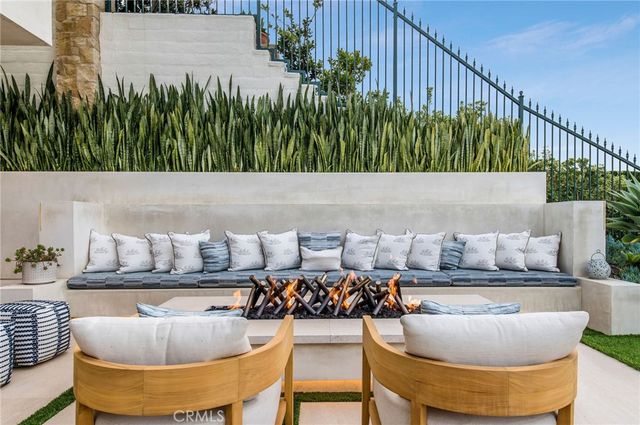 a roof deck with couches and wooden fence