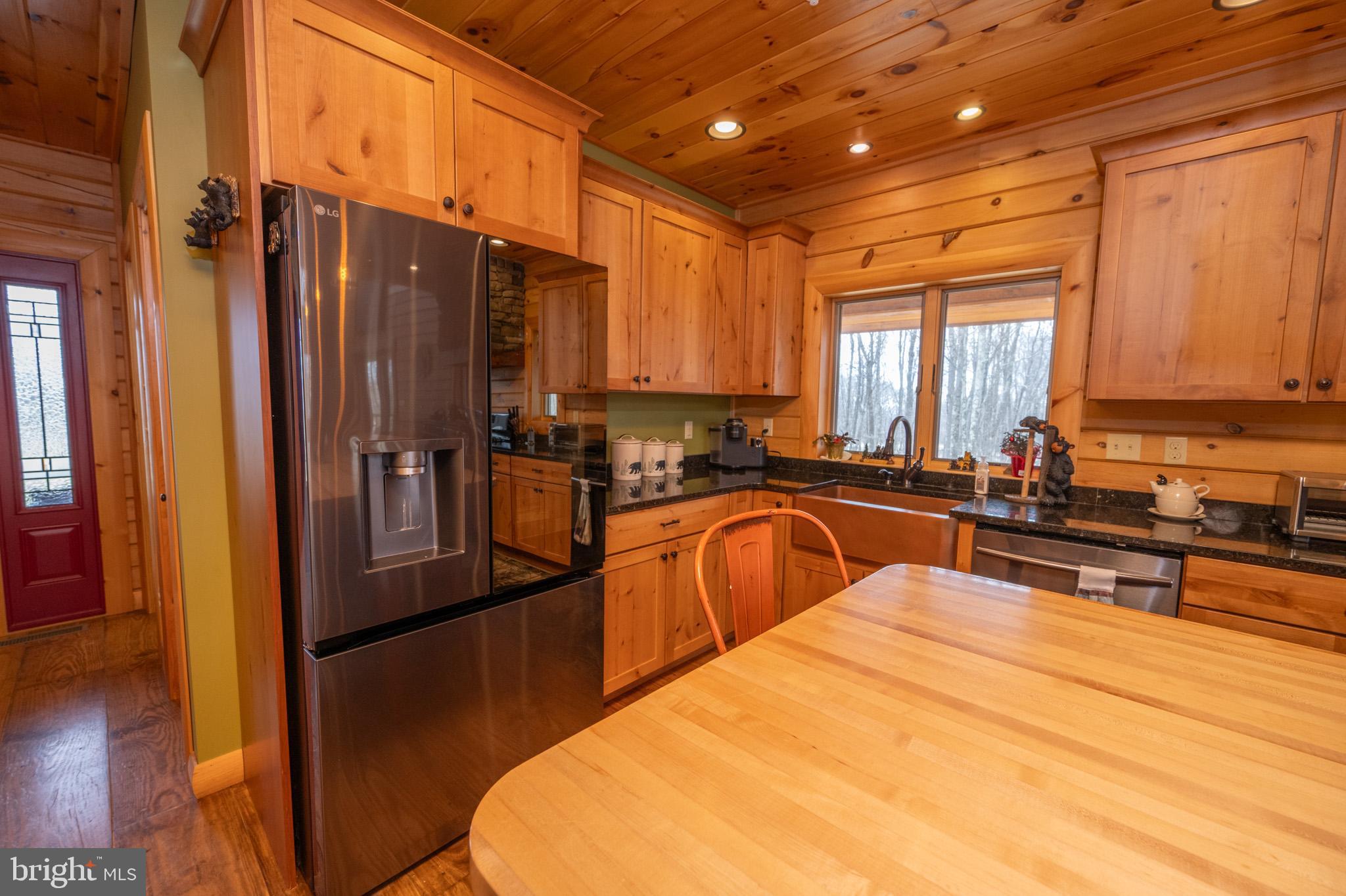 276 Sundance Way McHenry, MD 21541 - Photo 11 of 77 a large kitchen with stainless steel appliances a large counter top a stove a sink a refrigerator and cabinets