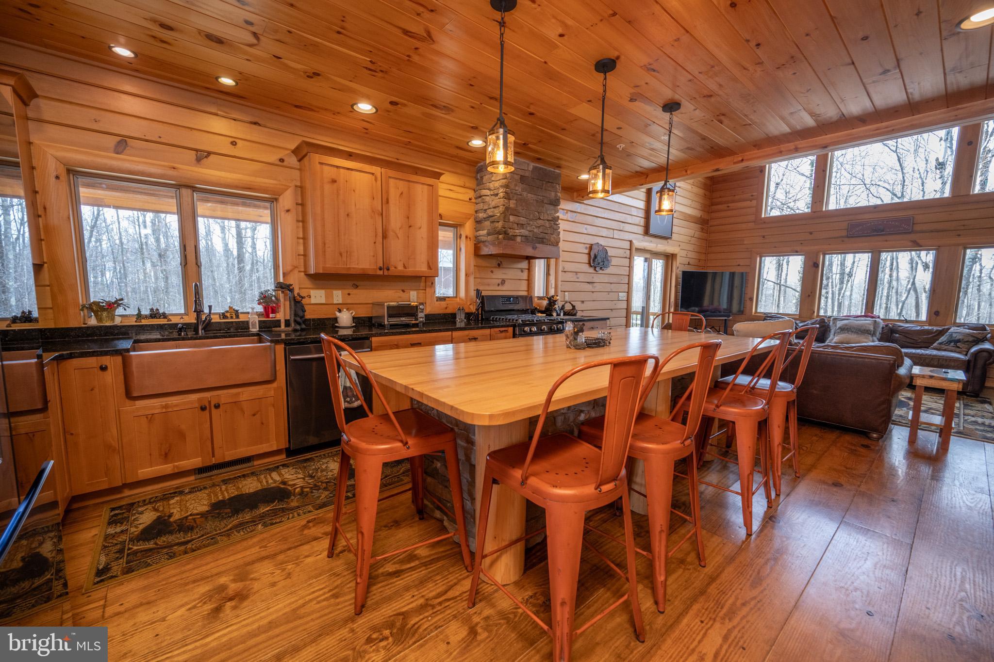 276 Sundance Way McHenry, MD 21541 - Photo 14 of 77 a view of a dining room with furniture window and wooden floor