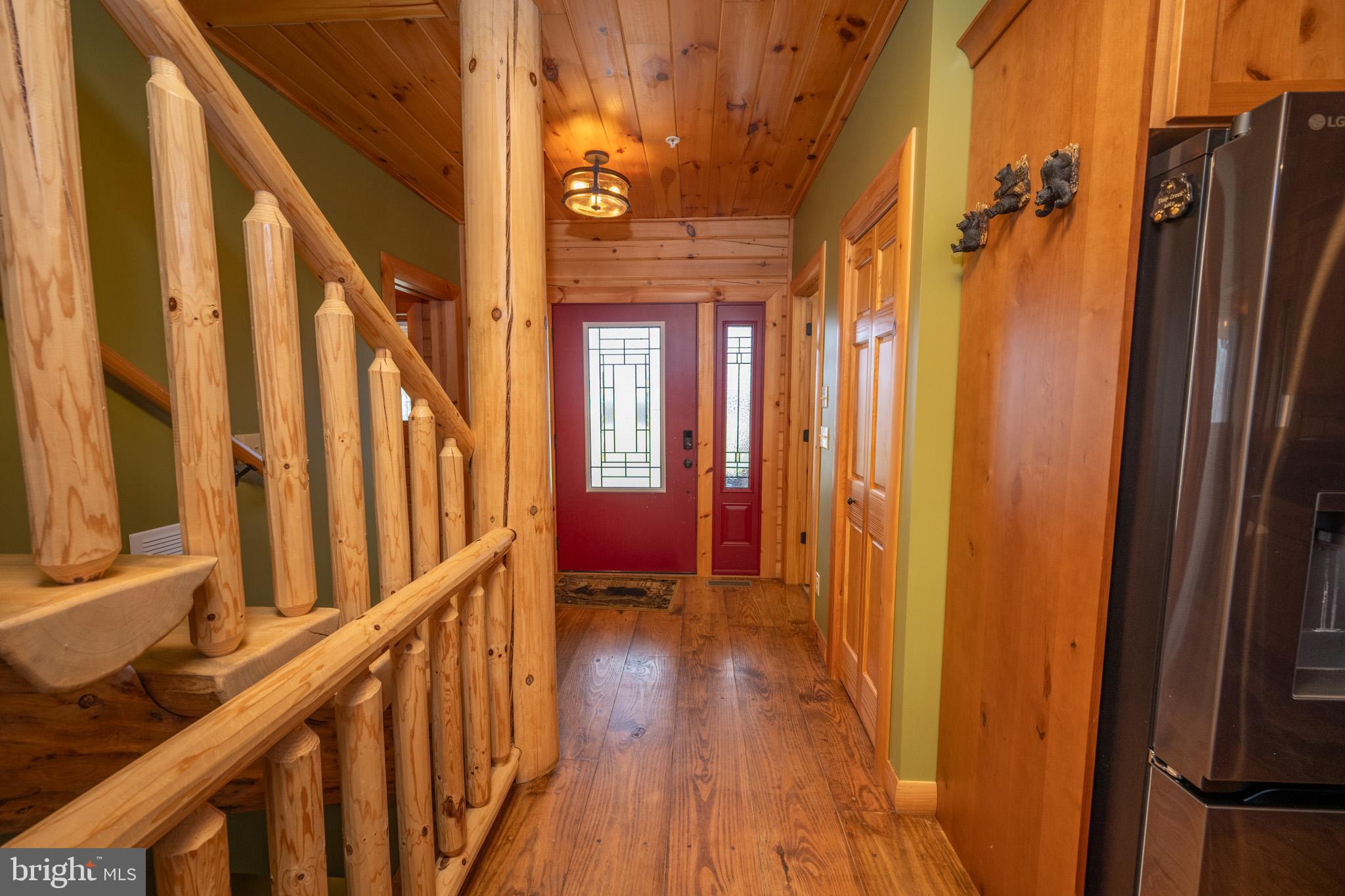 276 Sundance Way McHenry, MD 21541 - Photo 32 of 77 a view of a hallway with wooden floor and staircase