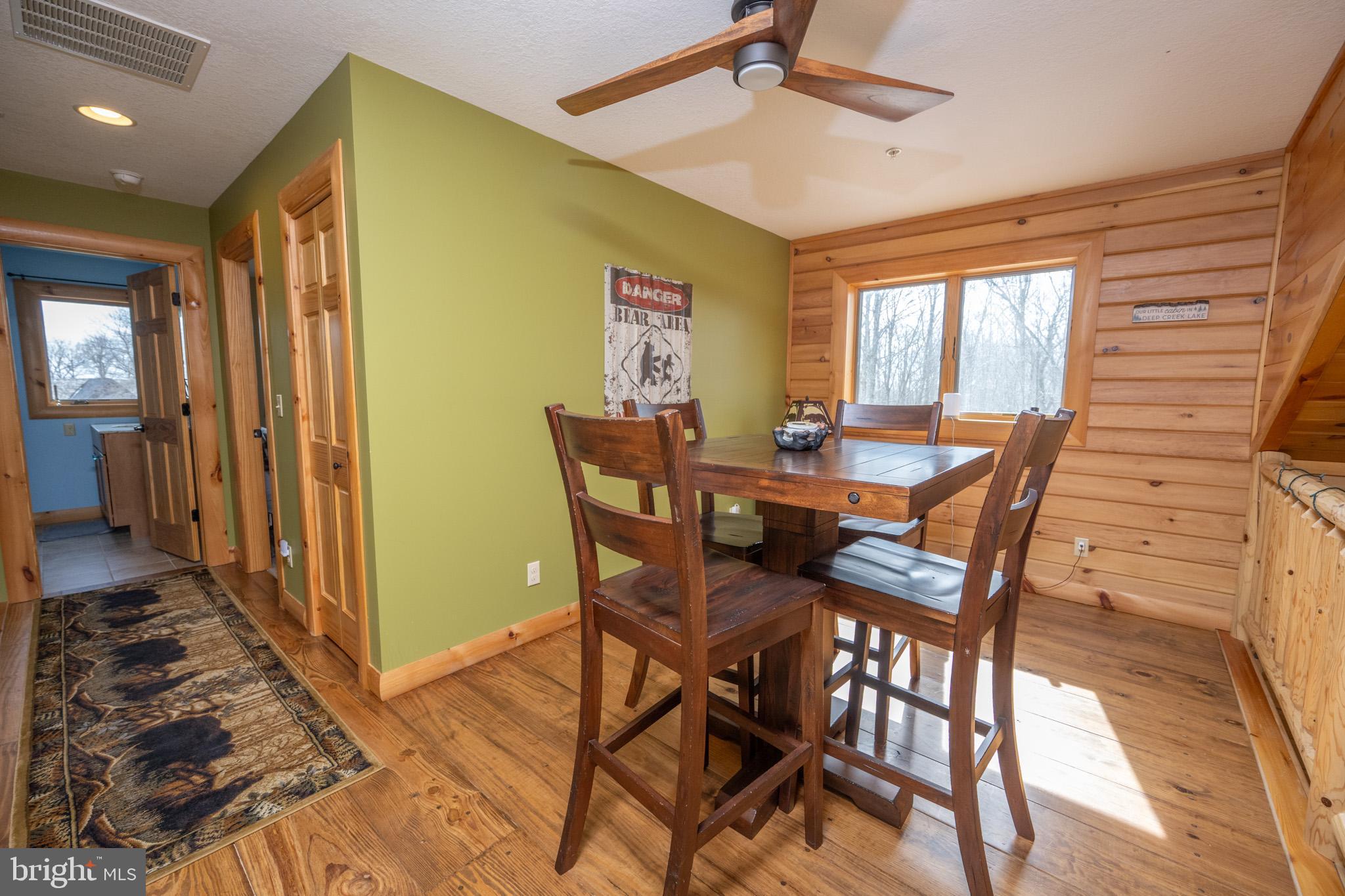 276 Sundance Way McHenry, MD 21541 - Photo 35 of 77 a view of a dining room with furniture window and wooden floor