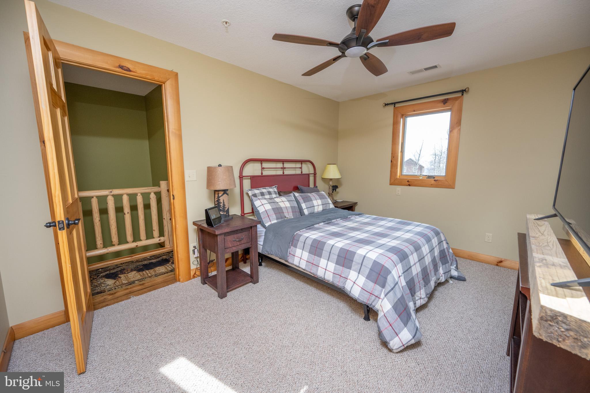 276 Sundance Way McHenry, MD 21541 - Photo 39 of 77 a bedroom with a bed and a chandelier