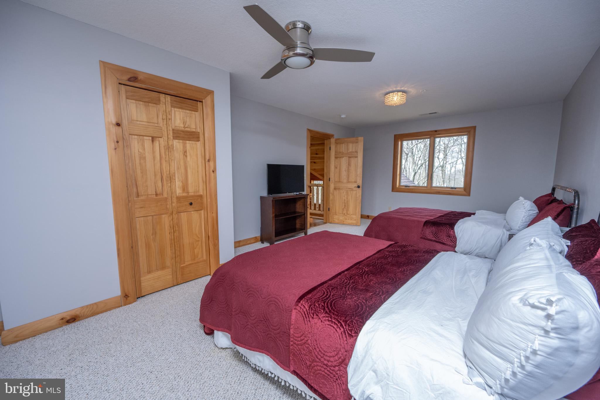 276 Sundance Way McHenry, MD 21541 - Photo 46 of 77 a bedroom with a large bed and a closet