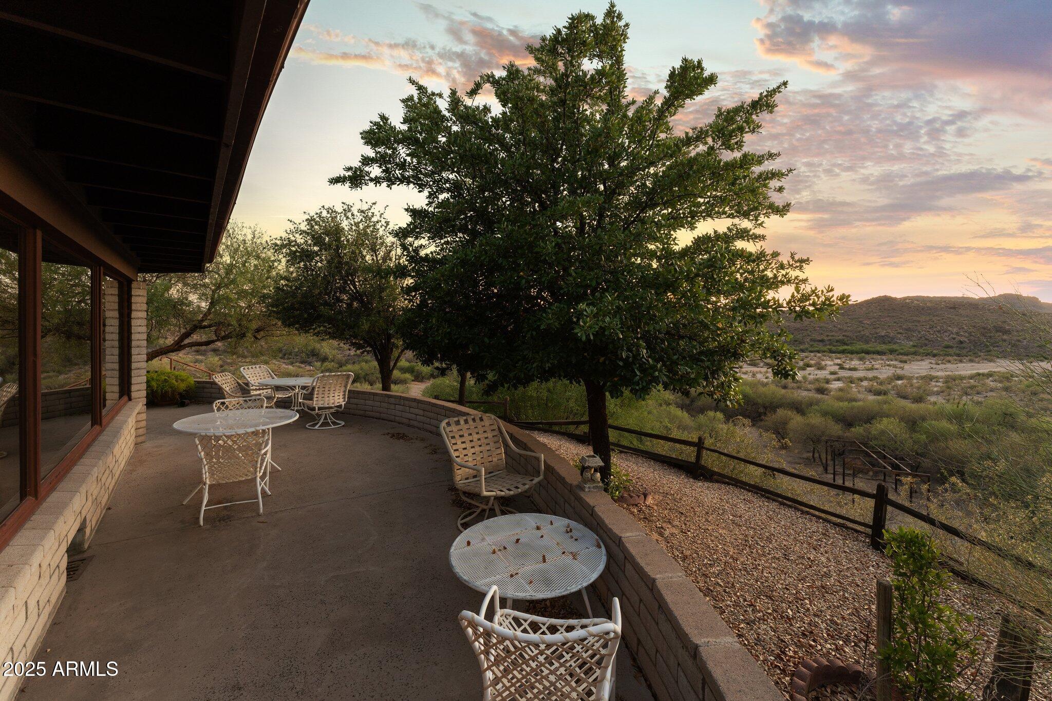 27610 Gill Road Morristown, AZ 85342 - Photo 53 of 71 a view of a patio with table and chairs and potted plants