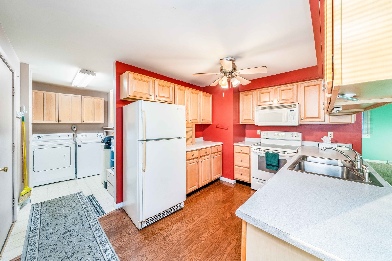 1014 Castle Street Sandwich, IL 60548 - Photo 7 of 21 a kitchen view with a stove a refrigerator and wooden floor