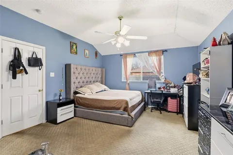 a bedroom with a bed workspace and window