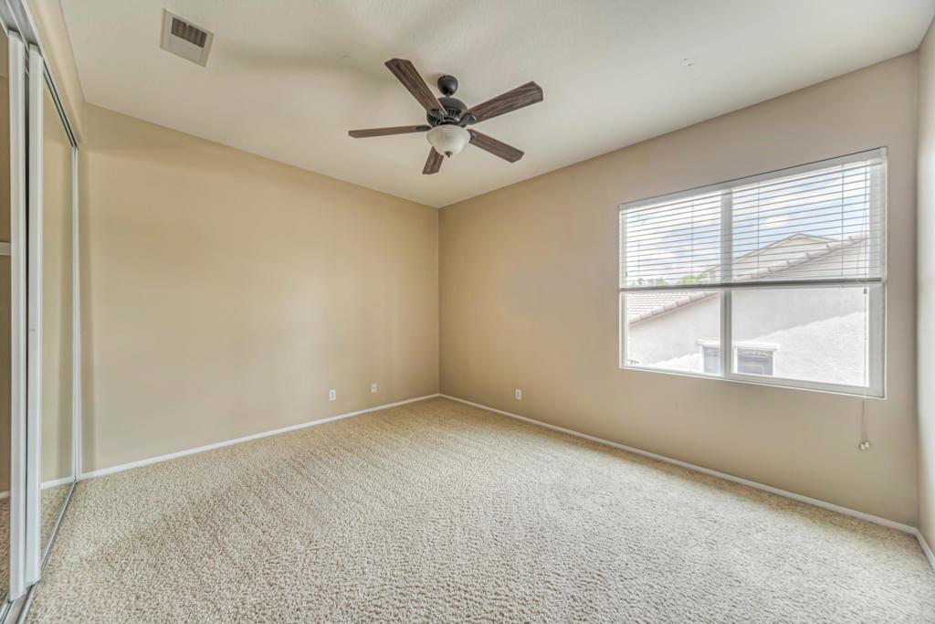 32215 Vía Bejarano Temecula, CA 92592 - Photo 16 of 42 an empty room with ceiling fan and windows