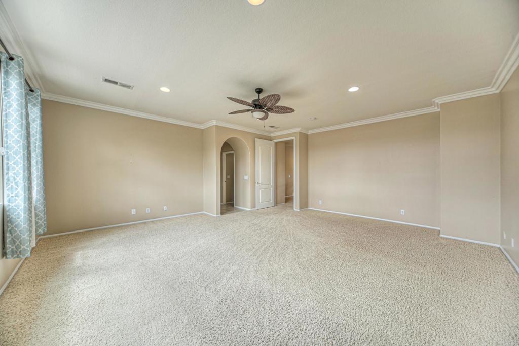 32215 Vía Bejarano Temecula, CA 92592 - Photo 21 of 42 an empty room with a ceiling fan and a window