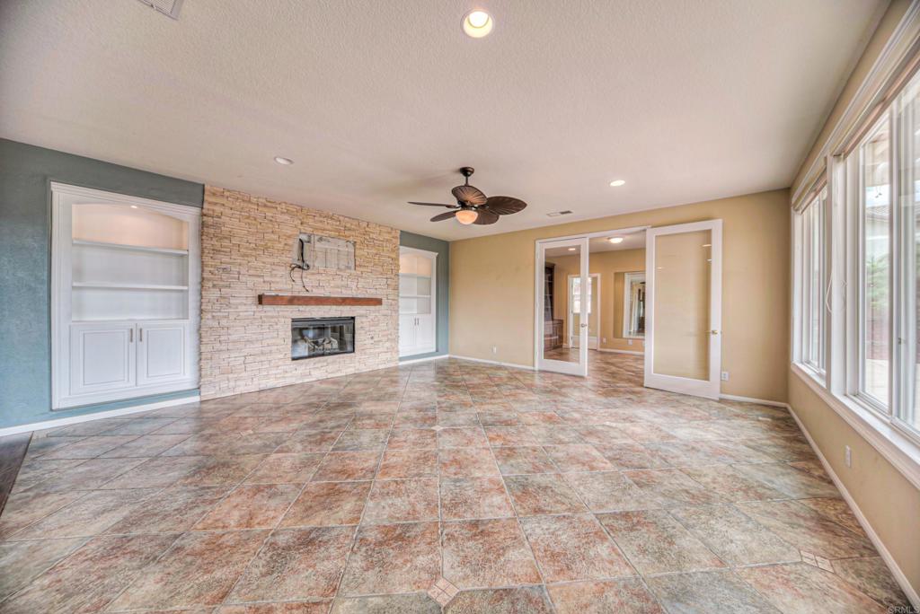 32215 Vía Bejarano Temecula, CA 92592 - Photo 34 of 42 a view of an empty room with a fireplace and a window