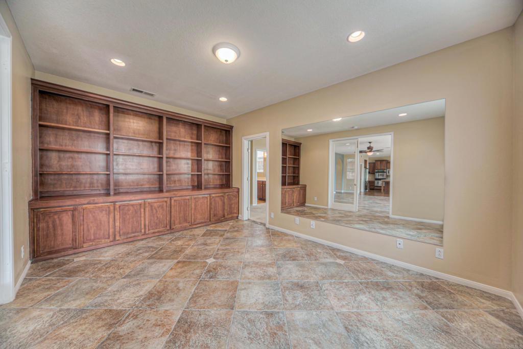 32215 Vía Bejarano Temecula, CA 92592 - Photo 35 of 42 a view of an empty room with a cabinet and mirrors
