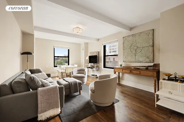 a living room with furniture a flat screen tv and a large window