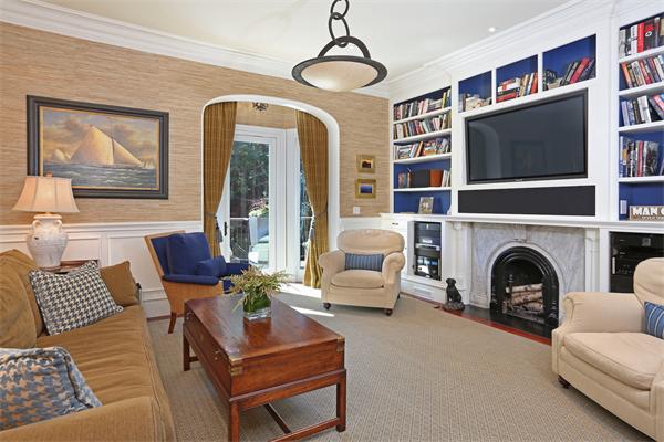26 Braddock Park Boston, MA 02116 - Photo 12 of 25 a living room with furniture a flat screen tv and a fireplace