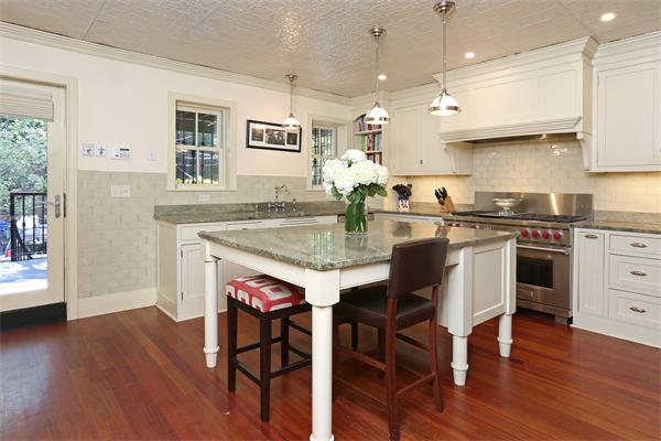 26 Braddock Park Boston, MA 02116 - Photo 3 of 25 a kitchen with a stove a sink a dining table and chairs