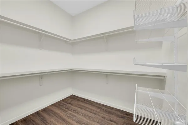 a view of a room with wooden floor