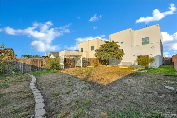 a backyard of a house with table and chairs