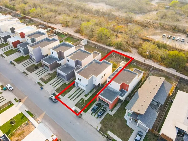 an aerial view of residential houses with outdoor space