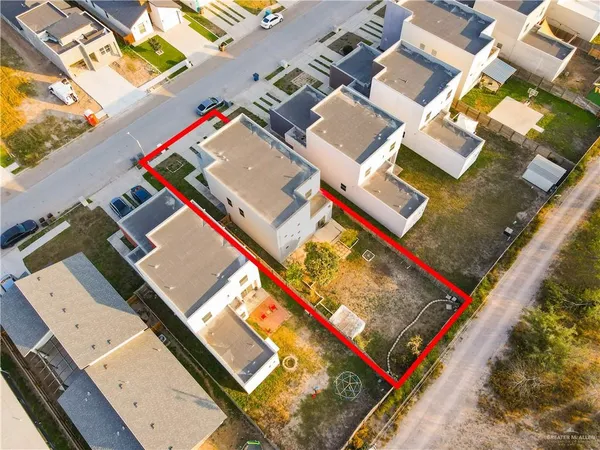 an aerial view of residential houses with outdoor space