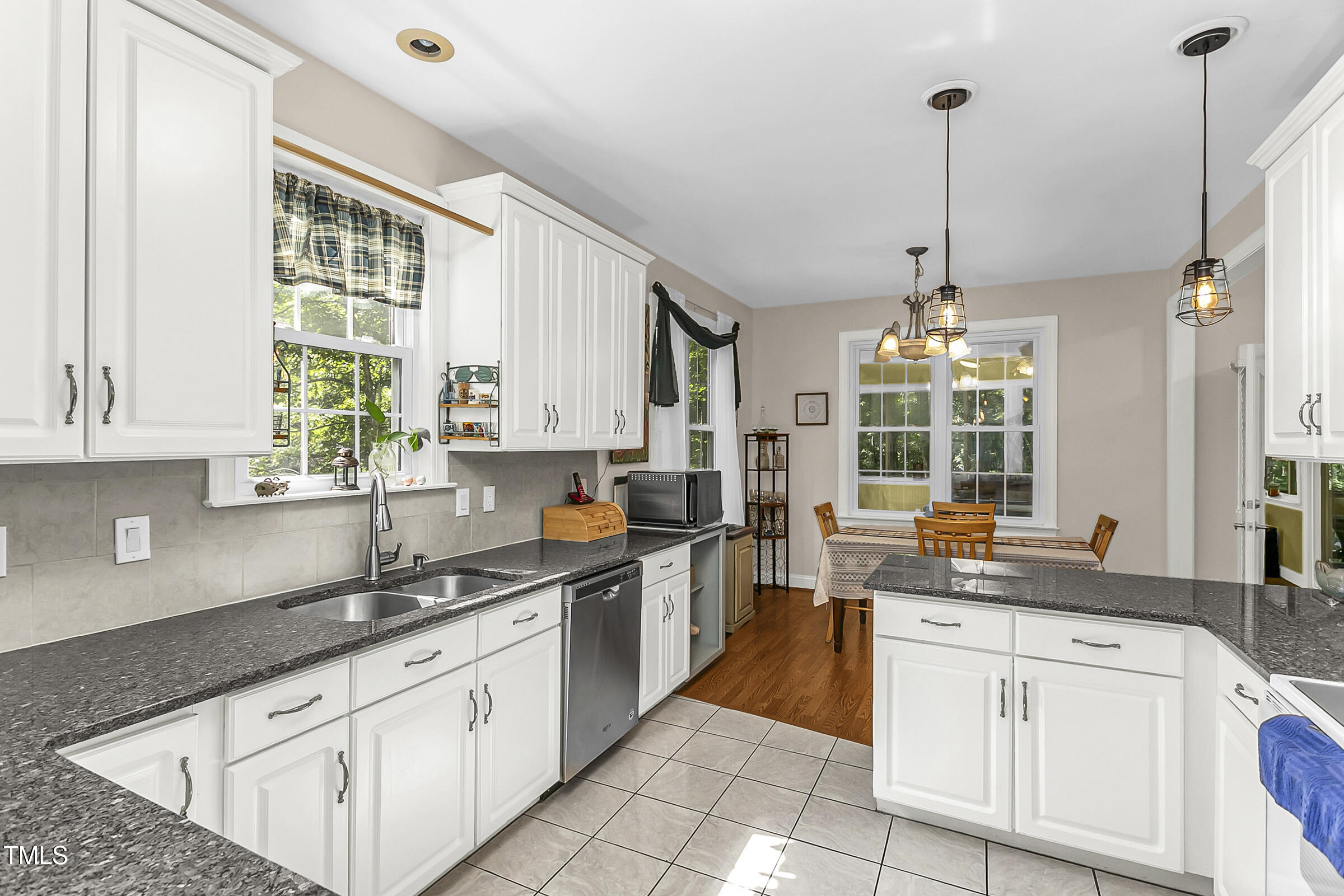 a kitchen with stainless steel appliances granite countertop a sink a stove and a granite counter tops