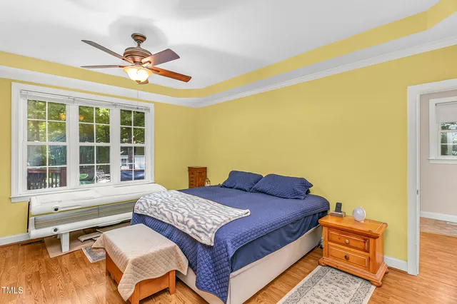 a bedroom with a bed and a window