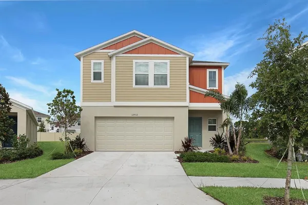 a front view of a house with a yard and garage