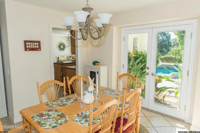 a dining room with furniture a chandelier and wooden floor