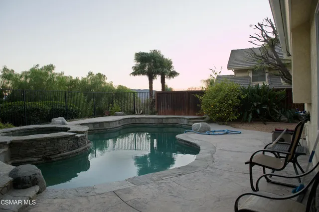 a view of swimming pool with outdoor seating and plants