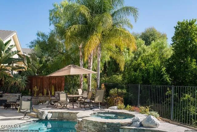 a swimming pool with outdoor seating and yard