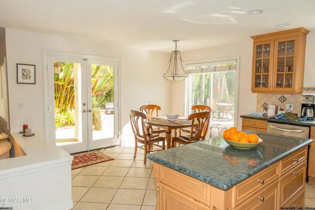 a kitchen with a table chairs and a granite counter top space