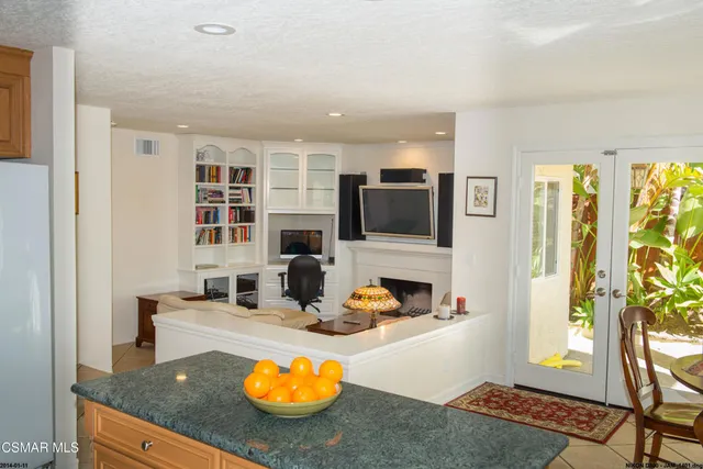 a kitchen with sink refrigerator and dining table