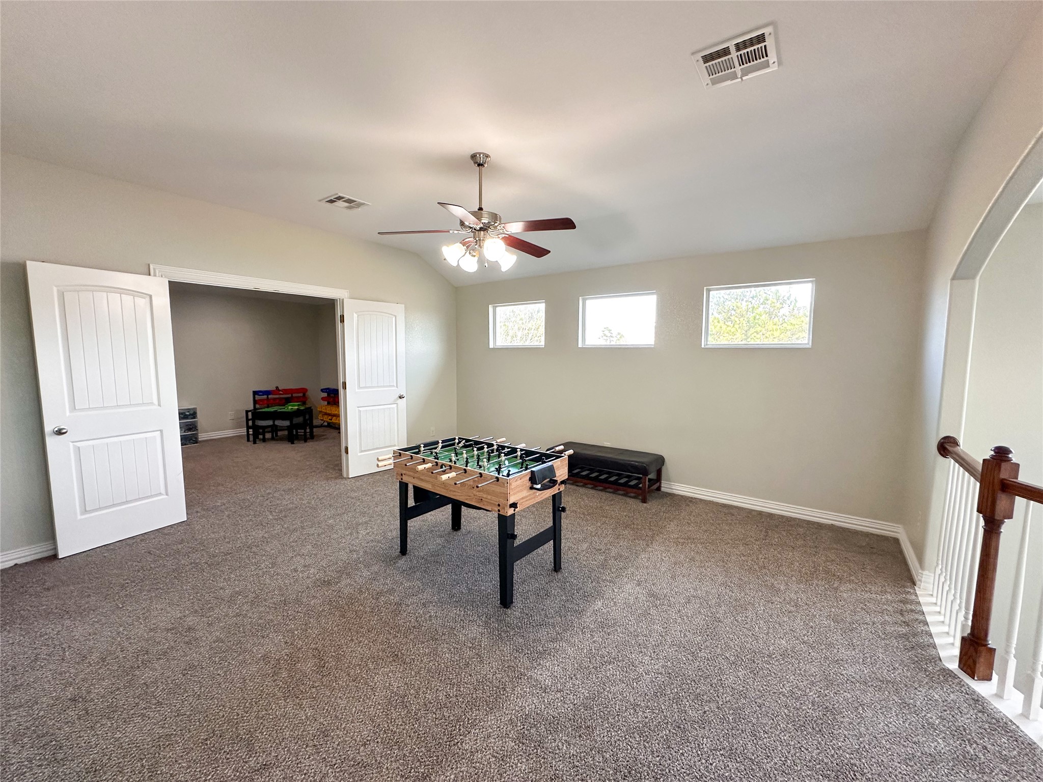 237 Cardinal Drive Paige, TX 78659 - Photo 22 of 37 Playroom featuring a ceiling fan, carpet, and vaulted ceiling