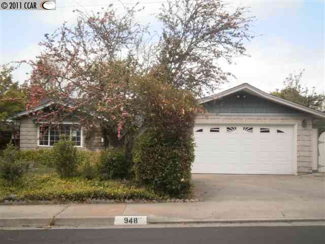 948 Hawthorne Drive Rodeo, CA 94572 - Photo 1 of 1 a front view of a house with a yard and garage