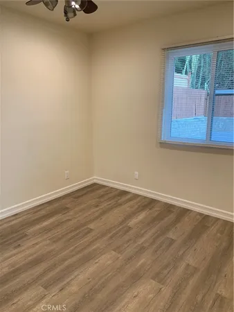 a view of a room with wooden floor and cabinet