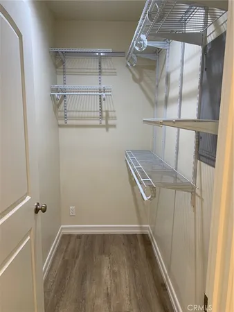 a view of walk in closet with empty racks