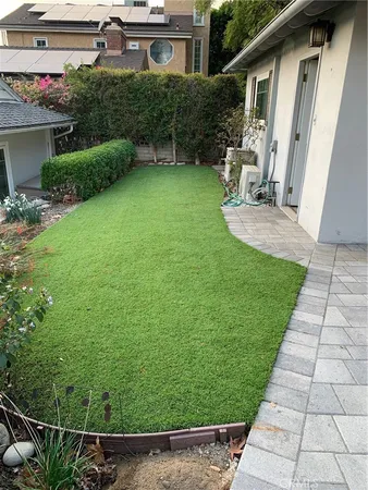 a view of a backyard with sitting area and garden