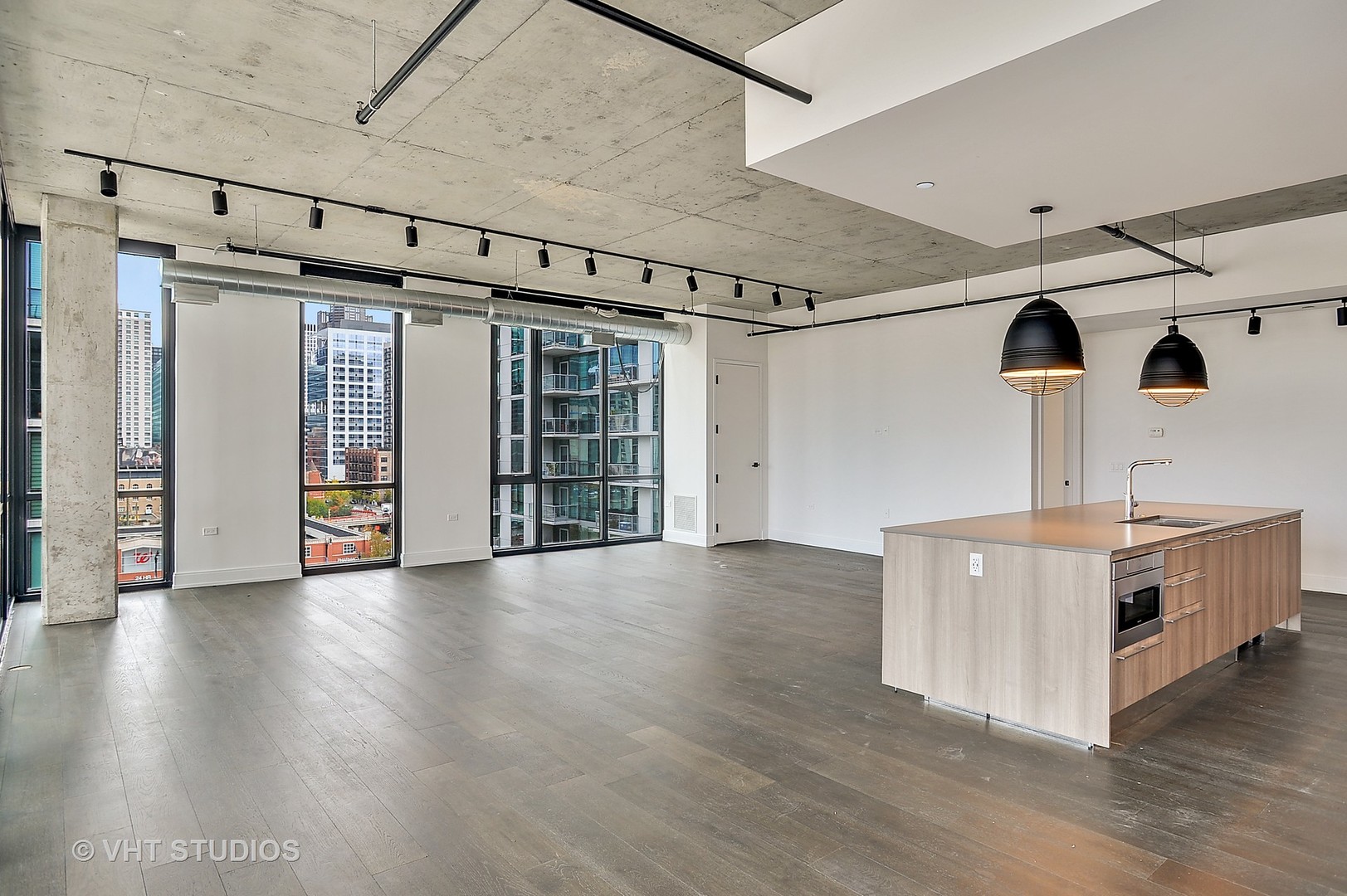 111 South Peoria Street, Unit 804 Chicago, IL 60607 - Photo 11 of 33 a view of an empty room with window and wooden floor