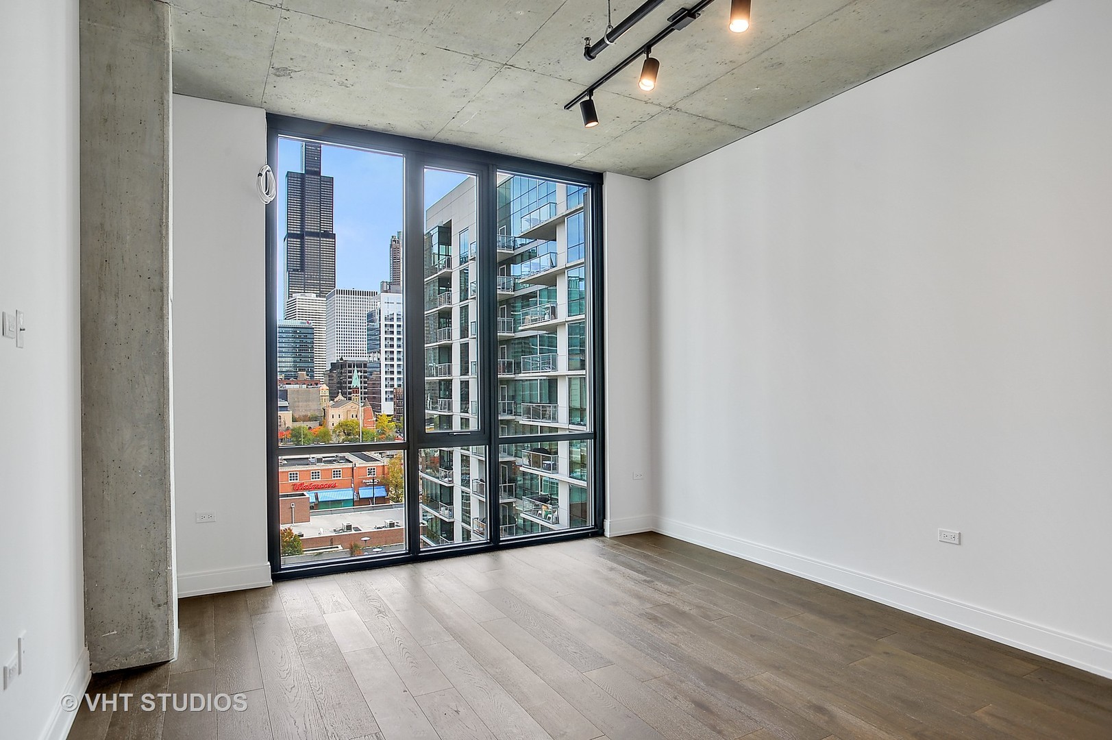 111 South Peoria Street, Unit 804 Chicago, IL 60607 - Photo 14 of 33 an empty room with wooden floor and windows