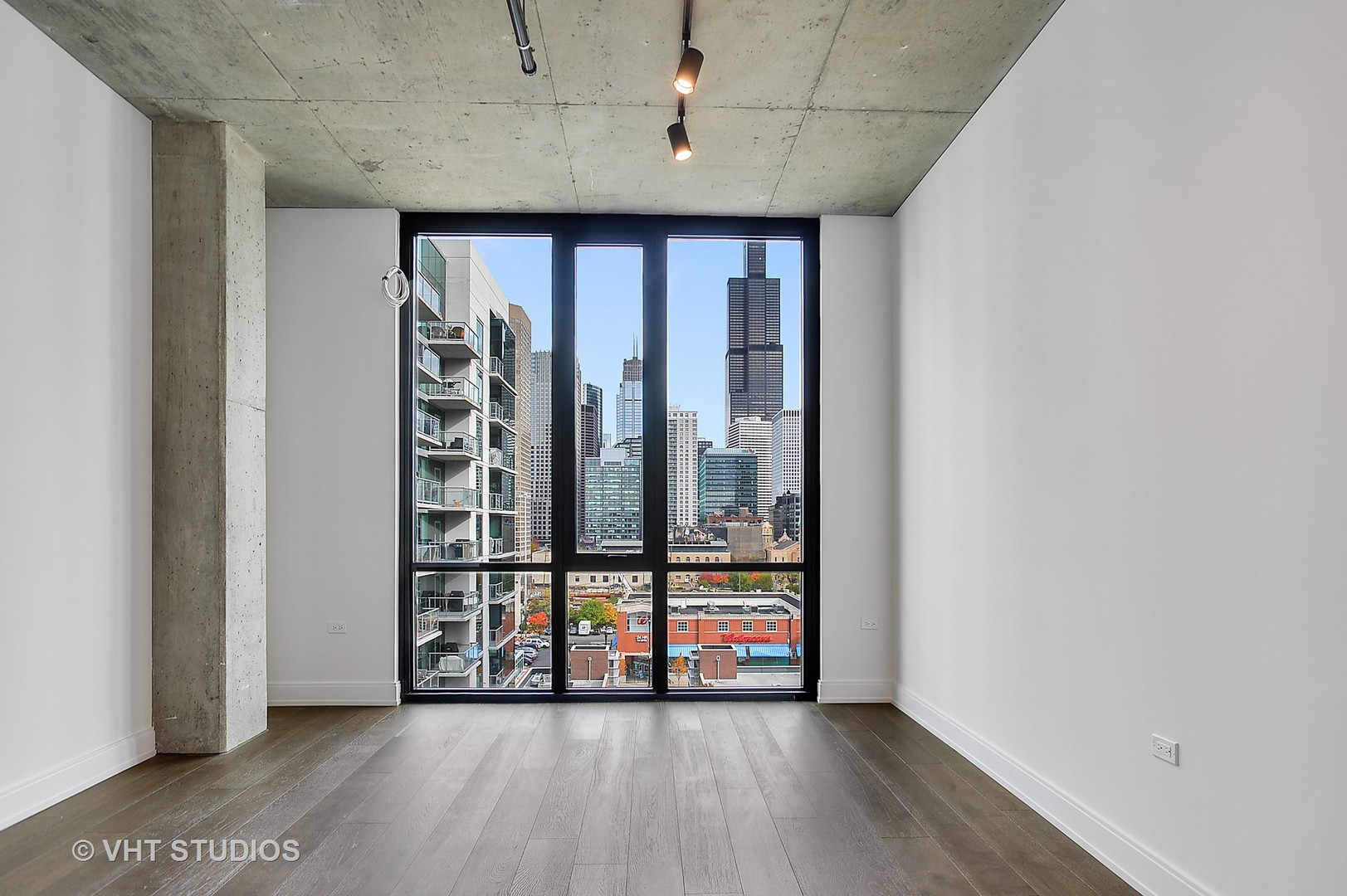 111 South Peoria Street, Unit 804 Chicago, IL 60607 - Photo 15 of 33 a view of an empty room with wooden floor