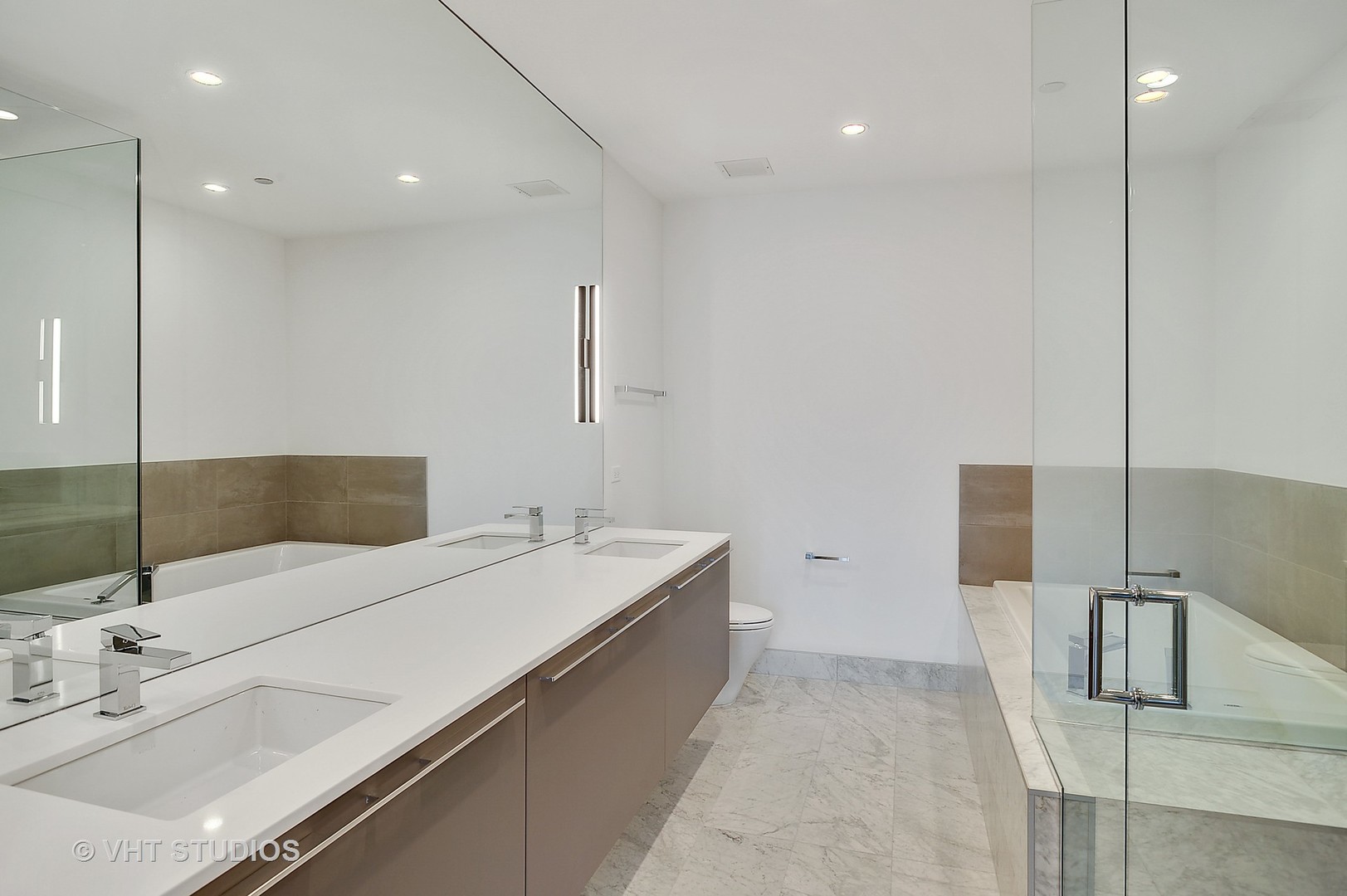 111 South Peoria Street, Unit 804 Chicago, IL 60607 - Photo 18 of 33 a bathroom with a double vanity sink a mirror and shower