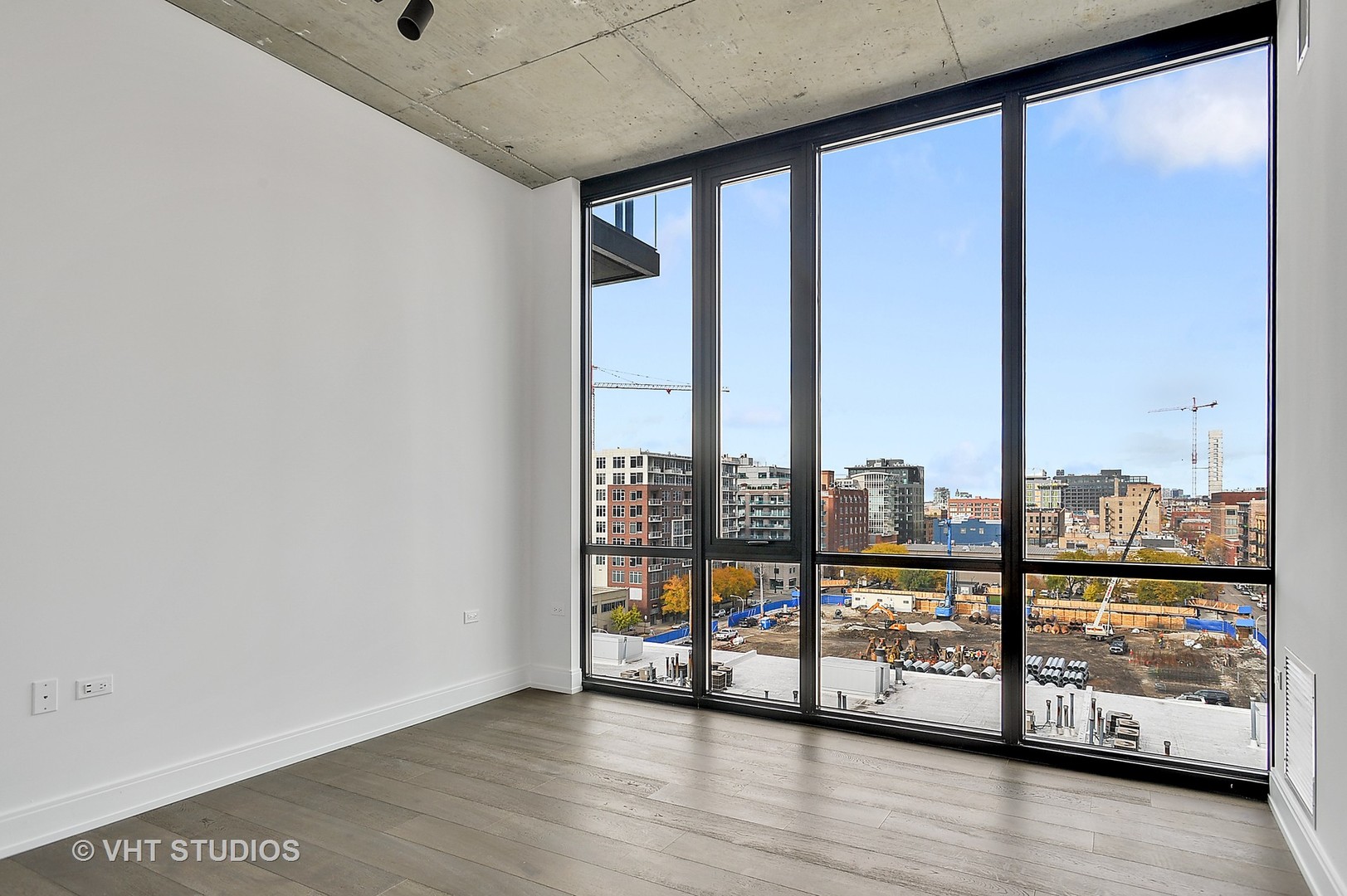 111 South Peoria Street, Unit 804 Chicago, IL 60607 - Photo 22 of 33 a view of an empty room with wooden floor and a window