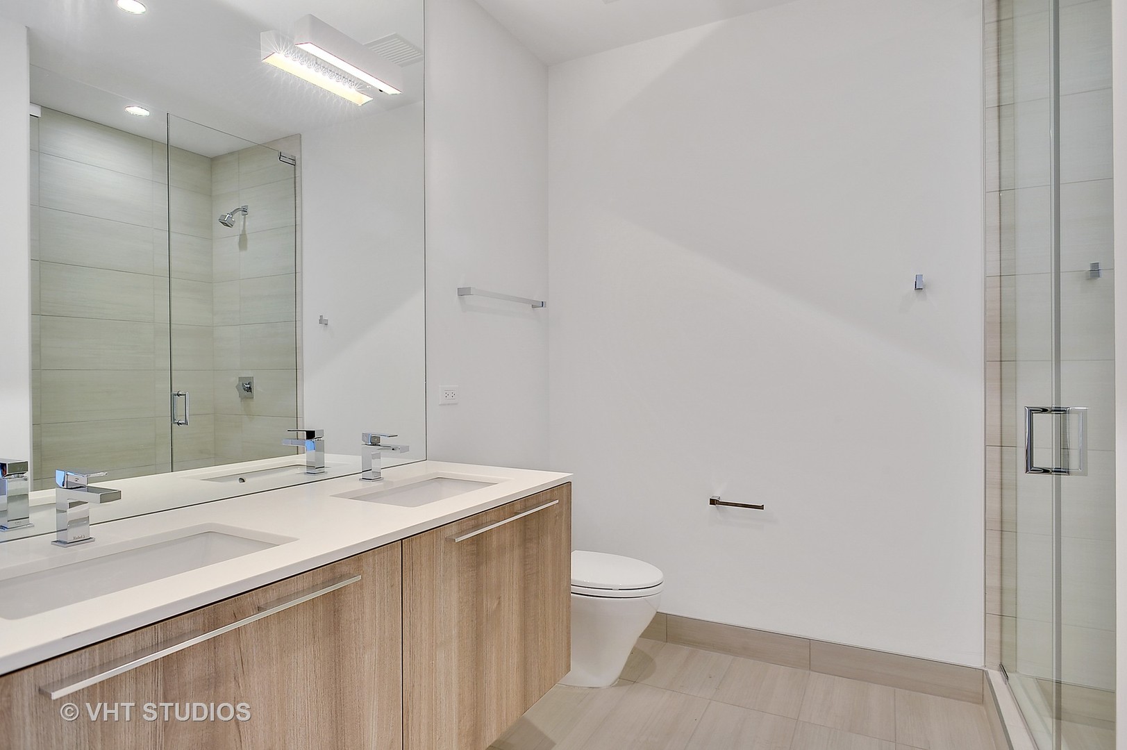 111 South Peoria Street, Unit 804 Chicago, IL 60607 - Photo 26 of 33 a bathroom with a sink a toilet and a mirror