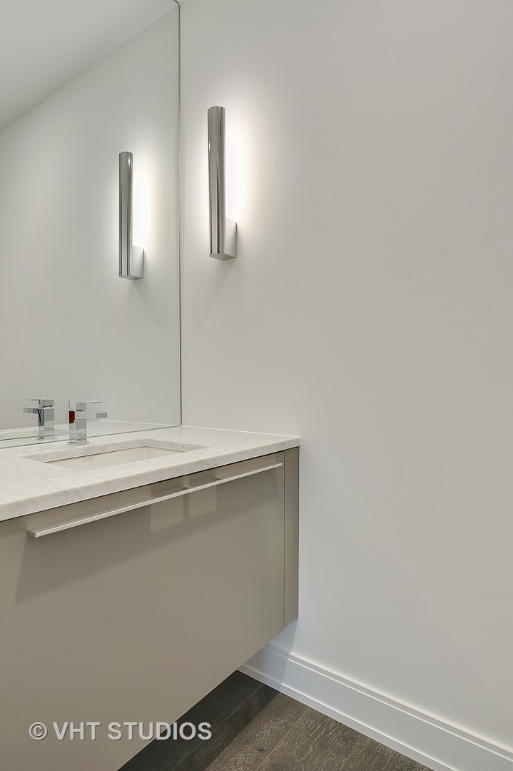 111 South Peoria Street, Unit 804 Chicago, IL 60607 - Photo 27 of 33 a bathroom with a sink and a mirror