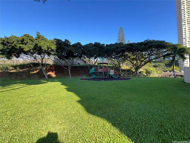 a view of a garden with a house in the background
