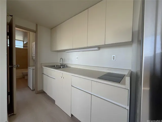 a kitchen with white cabinets and white appliances