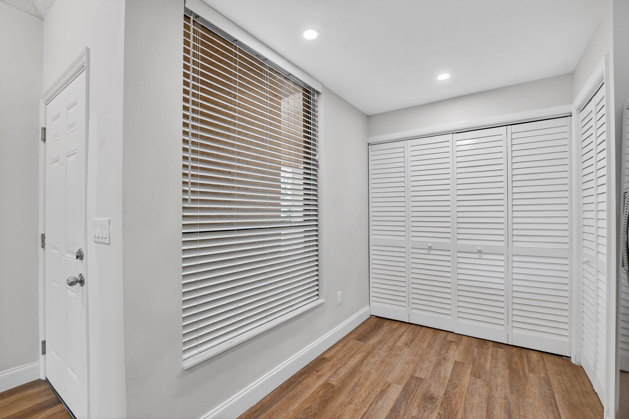 7472 La Paz Boulevard, Unit 304 Boca Raton, FL 33433 - Photo 12 of 36 a view of a room with wooden floor and a window