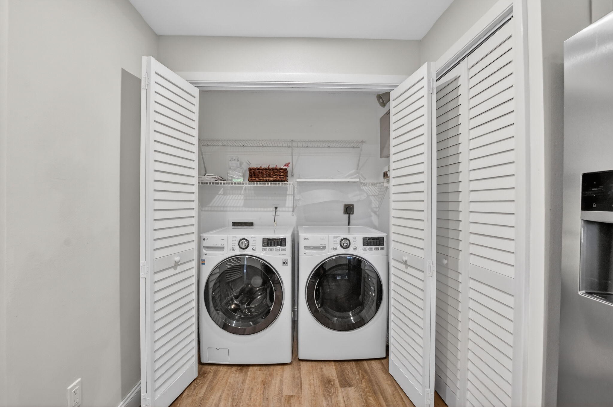 7472 La Paz Boulevard, Unit 304 Boca Raton, FL 33433 - Photo 13 of 36 a view of a bedroom with washer and dryer