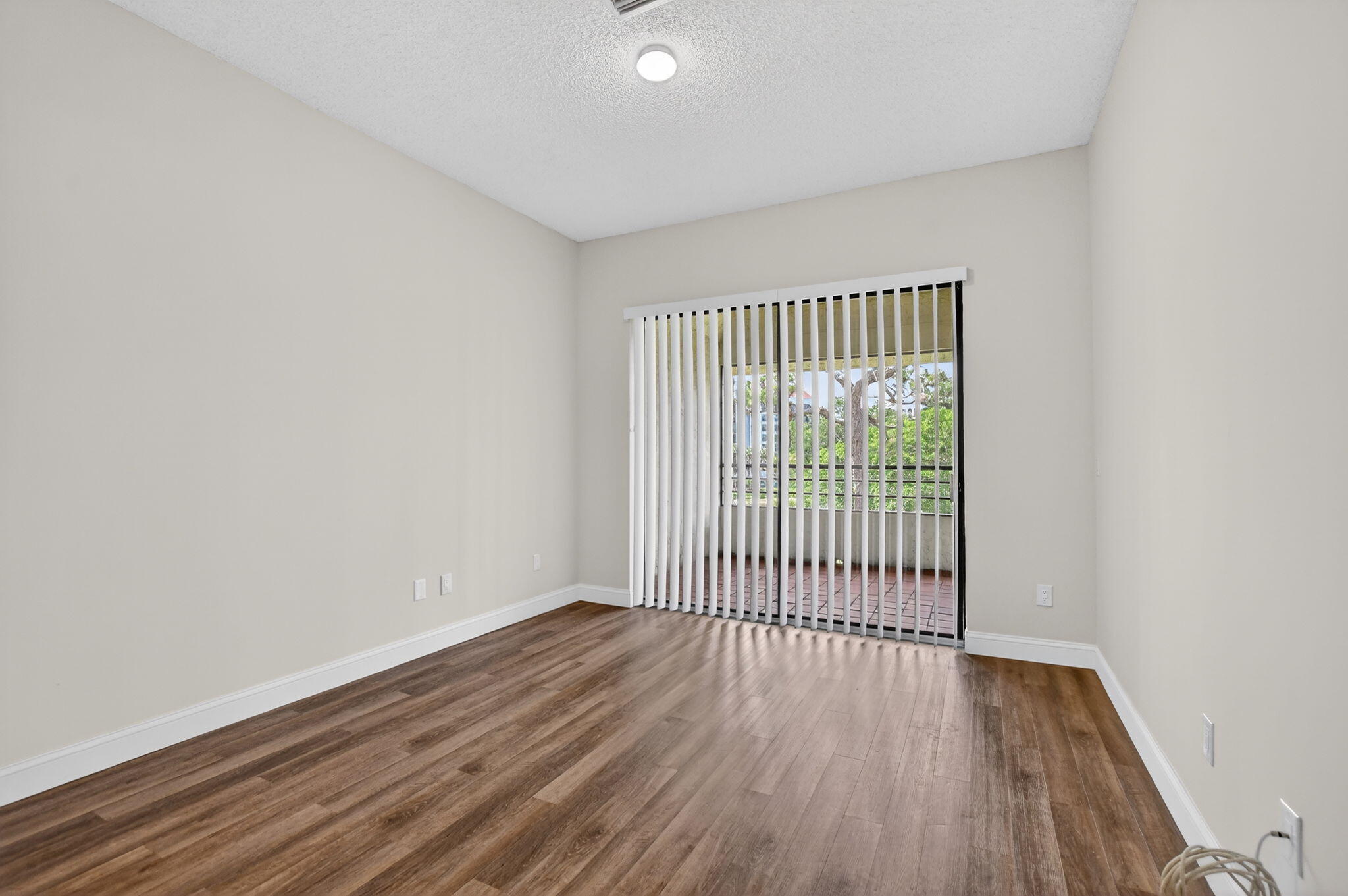 7472 La Paz Boulevard, Unit 304 Boca Raton, FL 33433 - Photo 17 of 36 a view of a room with wooden floor
