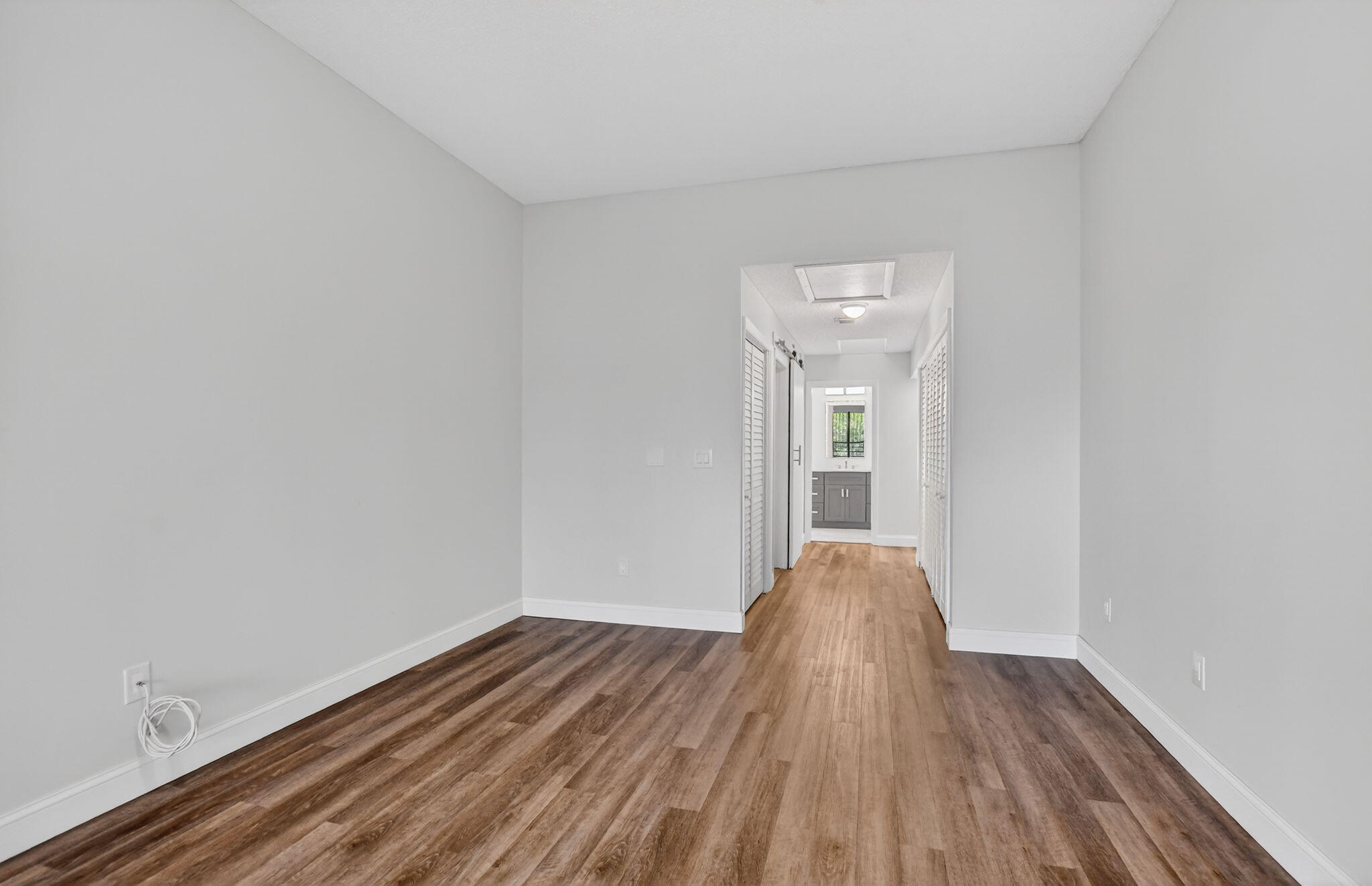 7472 La Paz Boulevard, Unit 304 Boca Raton, FL 33433 - Photo 18 of 36 a view of empty room with wooden floor and fan