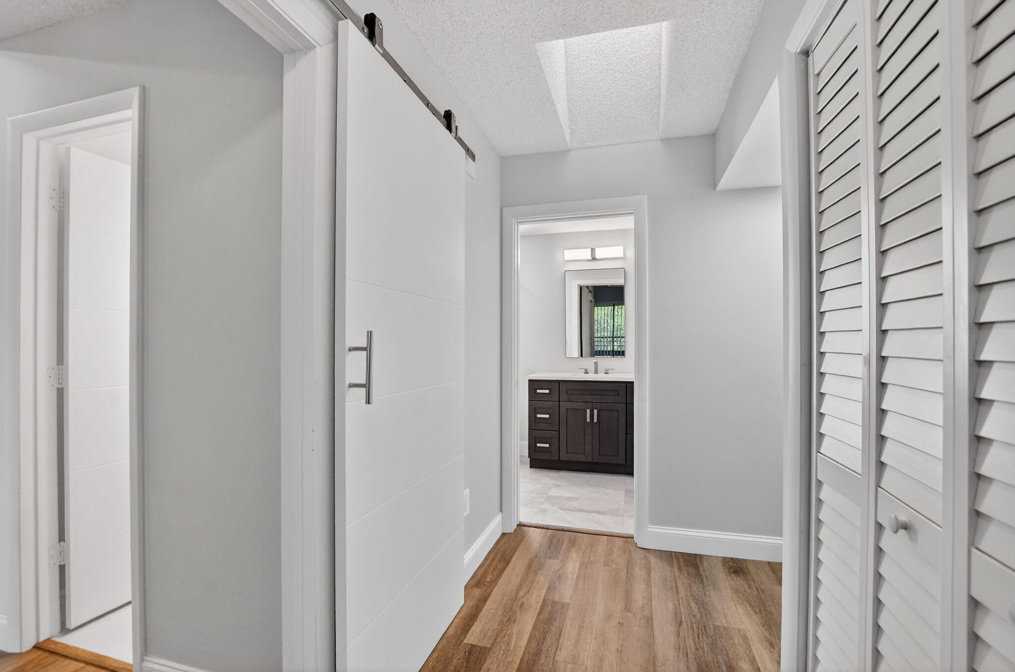 7472 La Paz Boulevard, Unit 304 Boca Raton, FL 33433 - Photo 19 of 36 a view of a hallway view with wooden floor and staircase