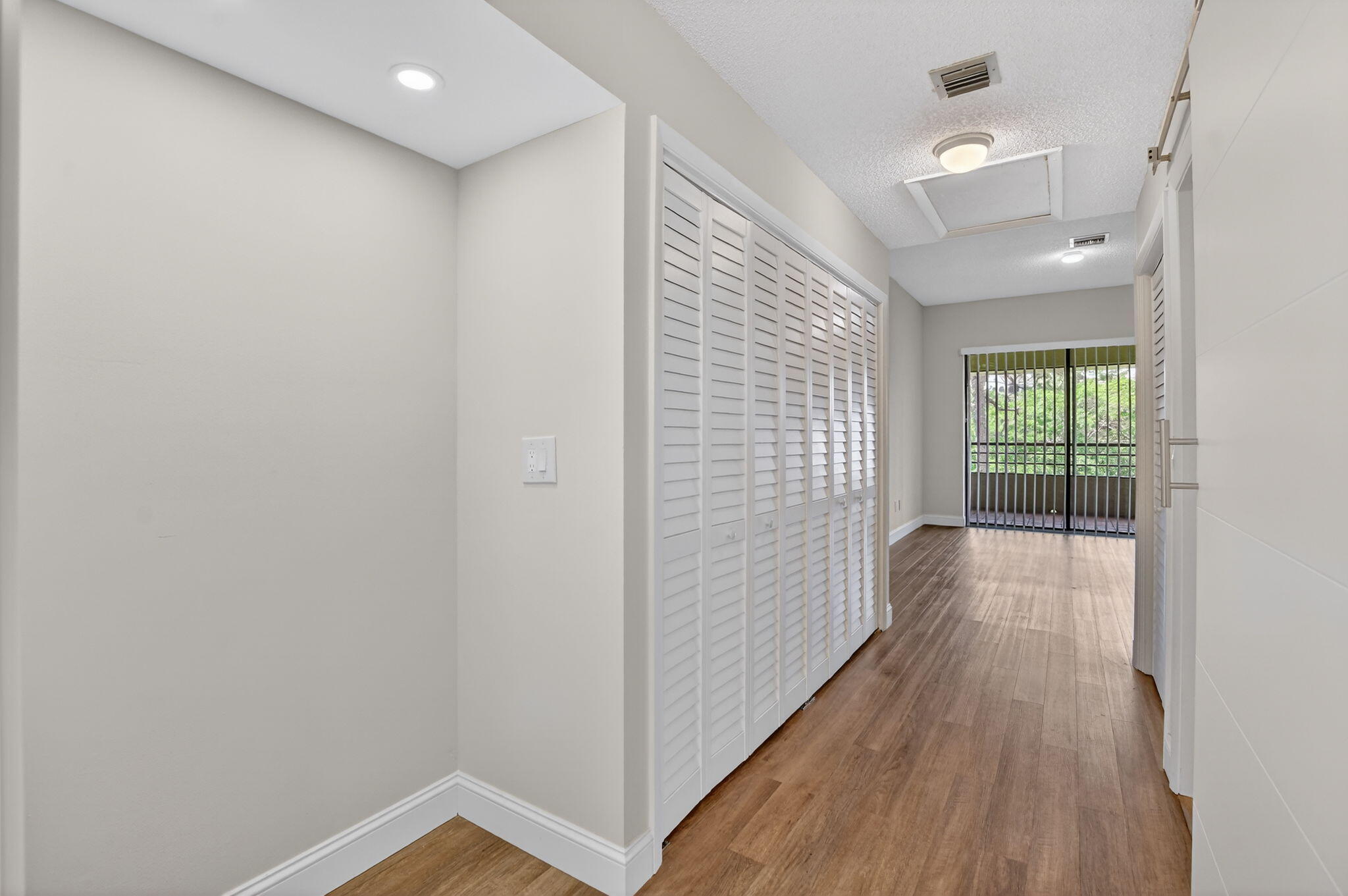 7472 La Paz Boulevard, Unit 304 Boca Raton, FL 33433 - Photo 20 of 36 a view of hallway with wooden floor