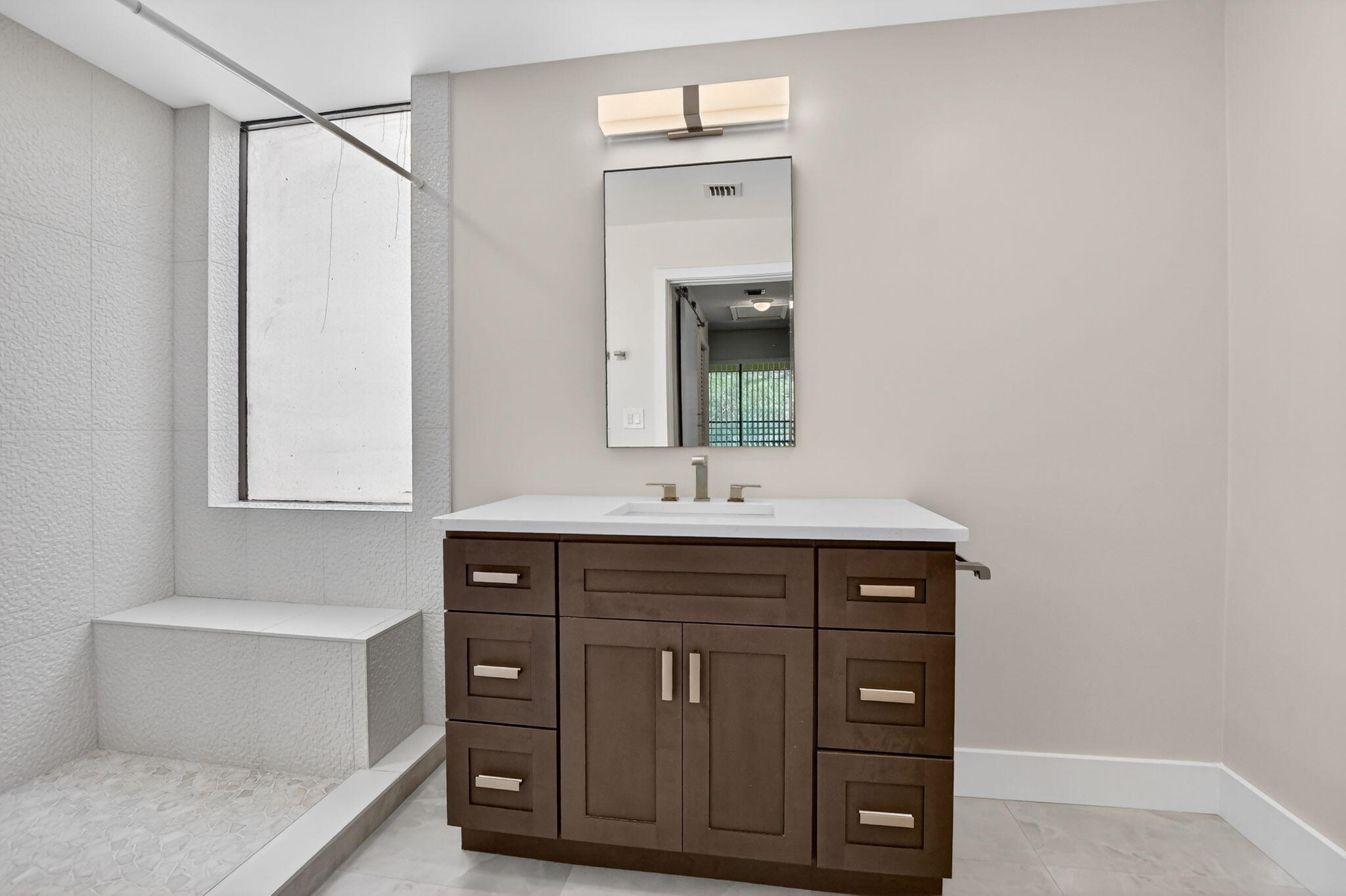 7472 La Paz Boulevard, Unit 304 Boca Raton, FL 33433 - Photo 21 of 36 a bathroom with a sink vanity and mirror